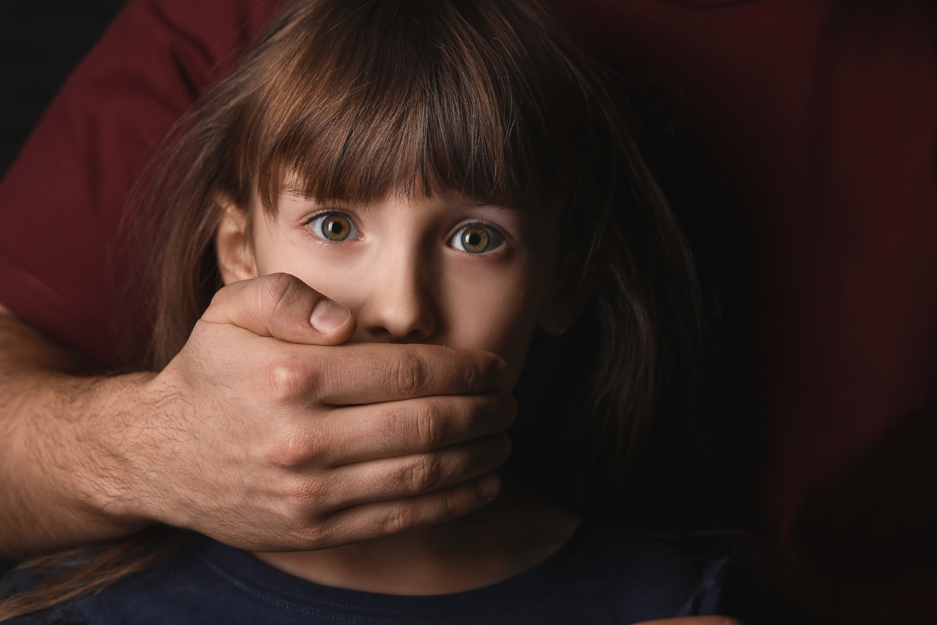 Person Covering Mouth of Scared Little Girl